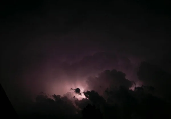 sheet lighting flashes across the clouds during a thunderstorm