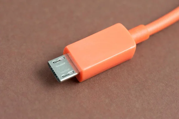 USB cable and plug, an industry standard for connecting peripherals and electronic devices to a computer allowing for the transmission of data