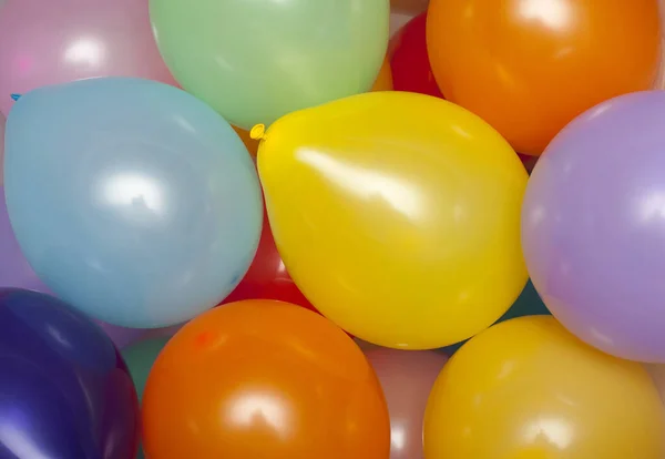 a background of various colored party baloons