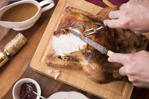 carving meat from a thanksgiving or celebration dinner roast turkey