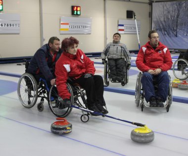 Team of young disabled people on game in curling clipart