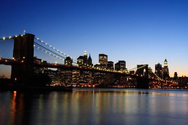 Brooklyn Bridge and Manhattan skyline at dusk - New York City, USA