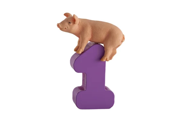 Toy piglet and a number one isolated on white — Stock Photo, Image