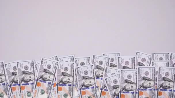 100 dollar bills wiggle on gray background. Stop motion video banner about money with copy space — Vídeo de stock