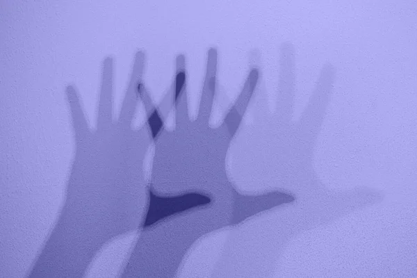 Monochrome shadows of a hand dancing to the music. Interactive exposition in science museum. Banner in trendy 2022 color — стоковое фото