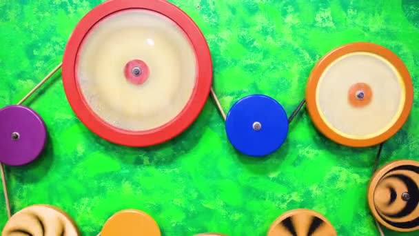 Interactive exposition in science museum for kids with colored rotating wheels. 4k resolution video. — Video