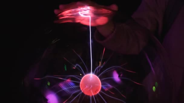 Working plasma globe or plasma lamp is a clear glass ball filled with a mixture of various noble gases with a high-voltage electrode in the center of the container. — Stock Video