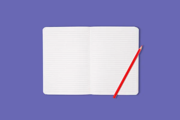 School or office notebook with red pencil isolated on purple background. Top view. Mock up. — Fotografia de Stock