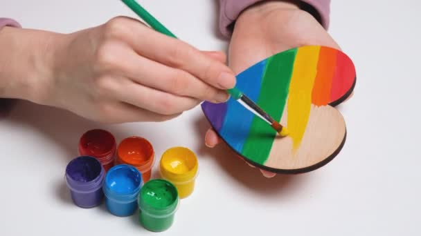 Ręcznie maluje drewniane serce w kolorach Gay Pride Flag. Kolorowy symbol LGBTQIA. Baner wideo rozdzielczości 4K — Wideo stockowe
