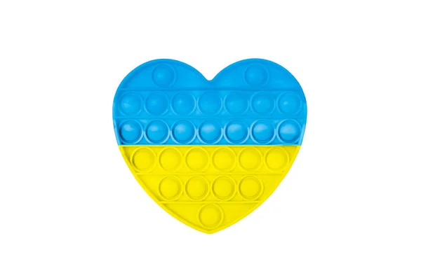 Κίτρινο και μπλε Pop It Antistress παιχνίδι. Pop Fidget Sensory Toy για Αυτισμό Ειδική Ανάγκες Ανακούφιση από το στρες σε μορφή καρδιάς. Ανακουφίζοντας το παιχνίδι με τη μορφή καρδιάς για παιδιά, παιδιά, ενήλικες. — Φωτογραφία Αρχείου