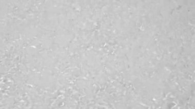 Transparent clear calm water surface texture with waves, splashes and bubbles. Trendy abstract nature background. White grey water waves in sunlight. Slow motion Full HD video banner.