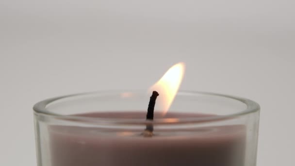 Brown Single Candle Flickering White Background Side View Candle Glass — Vídeos de Stock