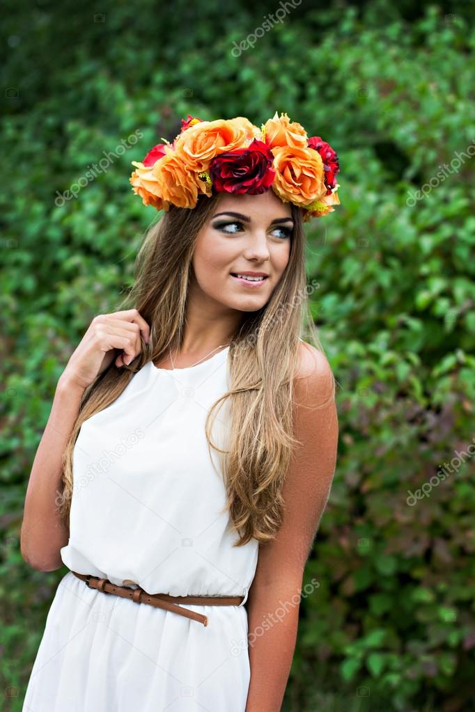 beautiful young woman with a wreath of flowers on her head