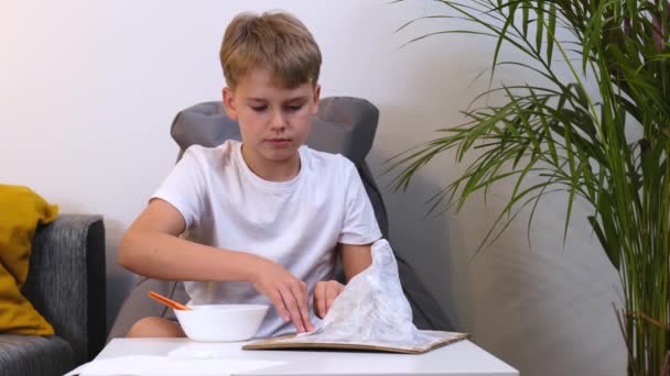 Schoolboy makes creative project in form of papier mache mountain. — Stock Video