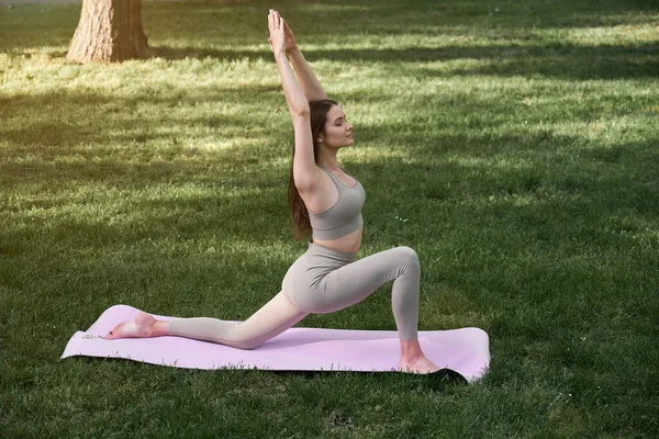 Ung Kvinna Utövar Yoga Stadspark När Hon Står Krigarpose Friluftsliv — Stockfoto