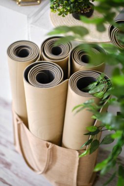 Yoga ya da bej renginde spor yapmak için birkaç lastik paspas bir stüdyonun ahşap zemininde. Spor aksesuarları