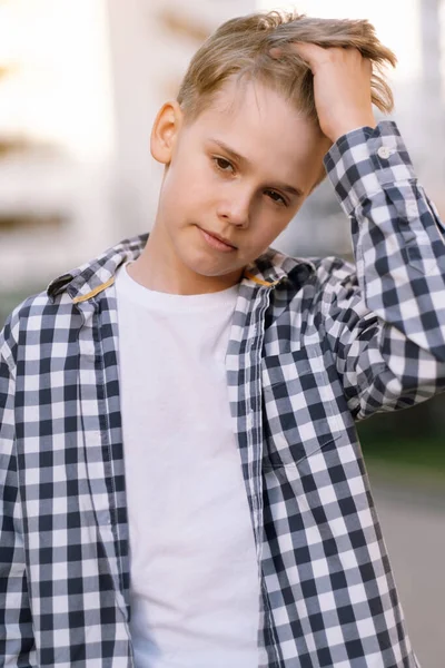 stock image Stylish teenager in casual clothes straightens his hair. Modern youth, lifestyle of teenagers