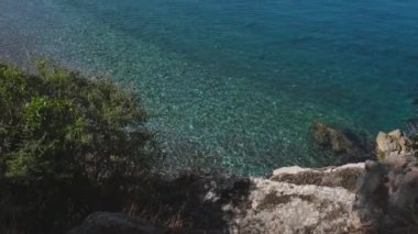 Karadağ 'da güneşli bir yaz gününde Sveti Stefan adası yakınlarındaki güzel mavi deniz. Adriyatik Denizi 'ndeki açık deniz suyu, Budva, Karadağ ve 4K ile Sveti Stefan' ın lüks turizm beldesi