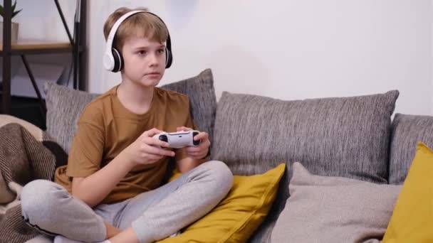 Pre Teen Boy Playing Video Game Joystick Sitting Sofa Home — ストック動画