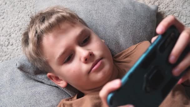 Pre Teenager Uses Smartphone Phone While Lying Floor Home Close — Stock Video