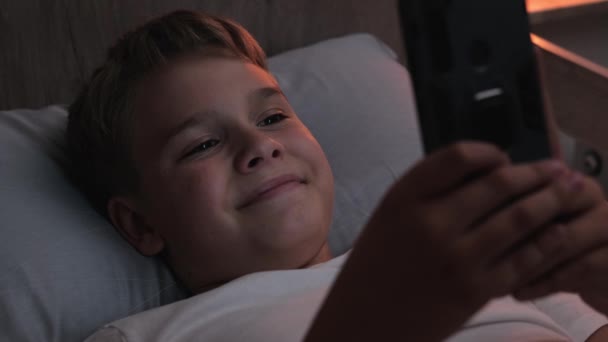 Happy Child Uses Phone While Lying Bed Late Night Teen — Video Stock