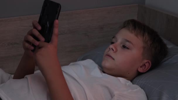 Male Teenager Lying His Bed While Scrolling Social Media His — Wideo stockowe