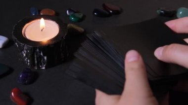 A woman lays down cards and blows out a candle after a divination session. The concept of divination and forecasting.