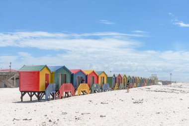 CAPE TOWN,  SOUTH AFRICA - DEC 23, 2021: Multi-colored beach huts at Muizenberg in Cape Town, Western Cape Province of South Africa