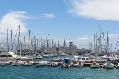 SIMONSTOWN,  SOUTH AFRICA - DEC 23, 2021: Harbour in Simonstown, Western Cape Province of South Africa. Boats and a Valour-class frigate of the South African Navy, the SAS Mendi, are visible
