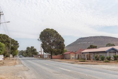 VICTORIA BATI, Güney Afrika - SEP 2, 2022: Victoria West, Kuzey Karoo Burnu 'nda bir sokak sahnesi. Kasabanın adı bir tepenin kenarındaki beyaz kayalarla yazılır.