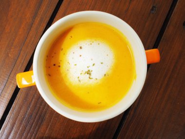 Ahşap masada balkabağı kremalı çorba 