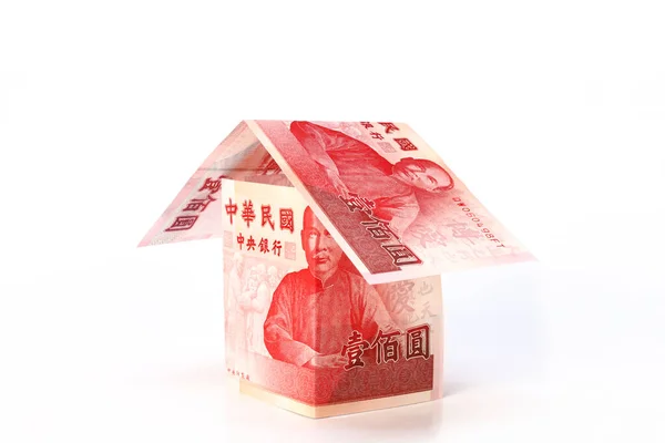 New Taiwan dollar banknotes paper house on white background. Concept of Investment property