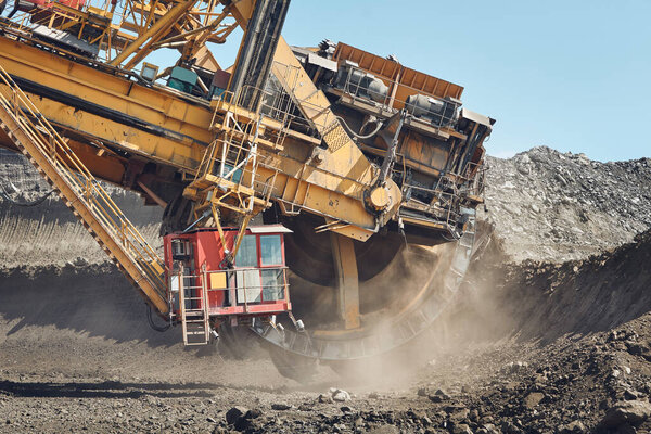 Coal mining in surface mine. Huge bucket excavator during mining