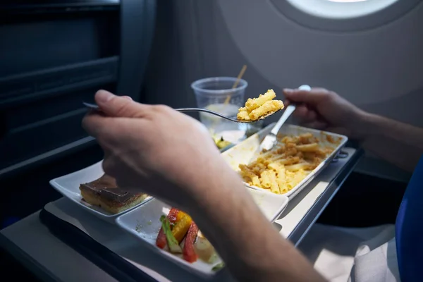 Passenger Eating Airline Meal Metal Cutlery Menu Pasta Vegetable Dessert — Stock Photo, Image
