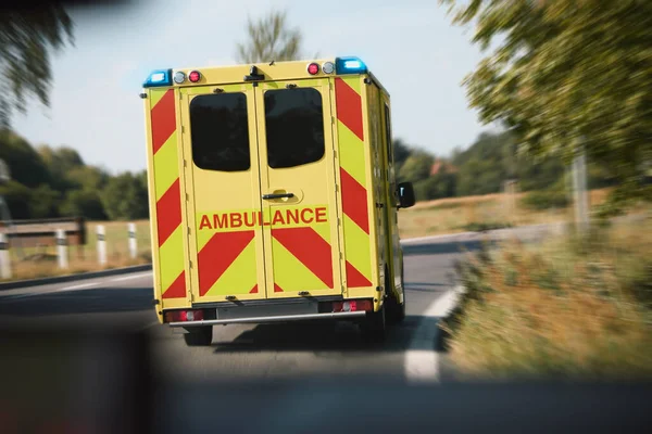 Ambulance car of emergency medical service on road in blurred motion. Themes rescue, urgency and health care