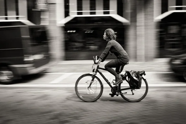 woman riding a bicycle down the street. Amsterdam