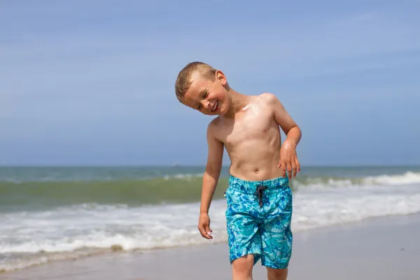 Laughing boy on beach after a swim — Stock Photo, Image