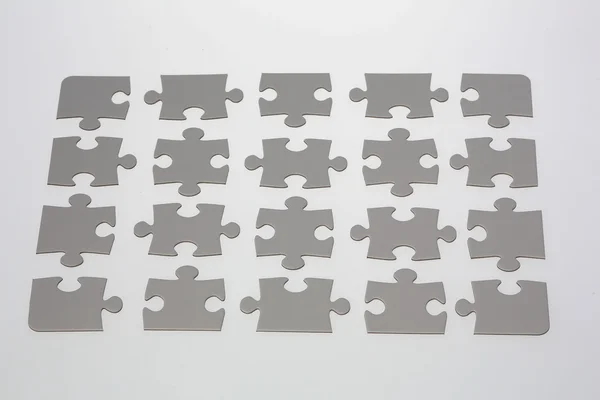 Gri jigsaw puzzle parçaları — Stok fotoğraf