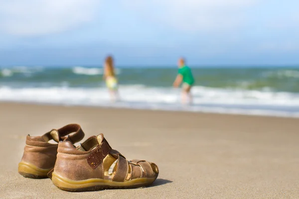 Kid sandals with blurred boy and girl Stock Image