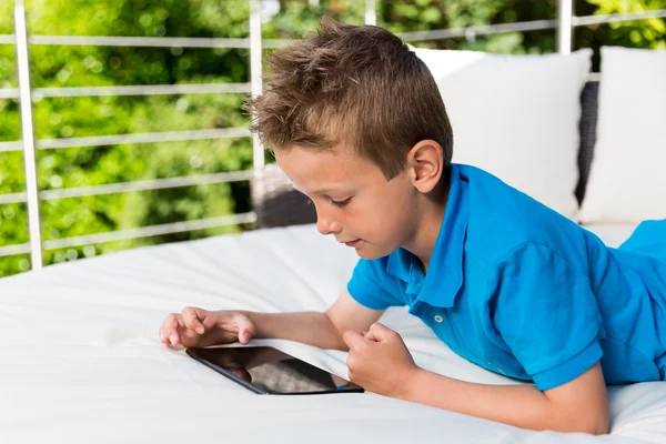 Boy tapping on tablet — Stockfoto