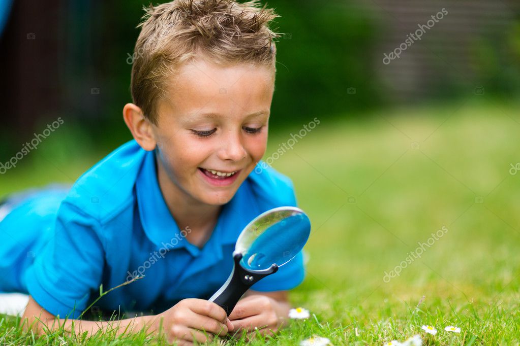 Boy with magnifier — Stock Photo © Bigandt 48073915