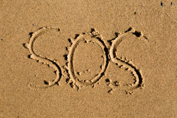 SOS in sand — Stock Photo, Image