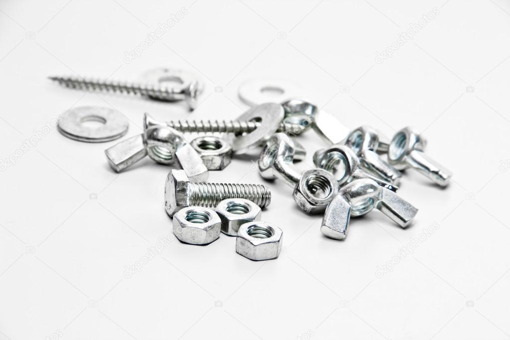 Nuts, screw, wing nut, flat washers on a white background