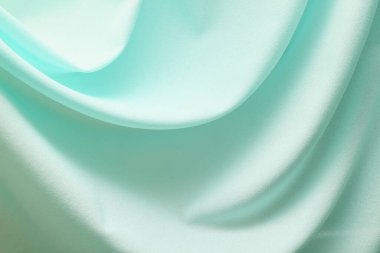 Turkuaz malzeme yumuşak katlanmış arka planda akar