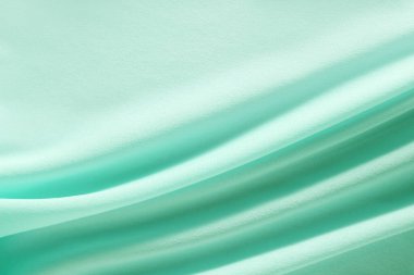 Turkuaz malzeme yumuşak katlanmış arka planda akar