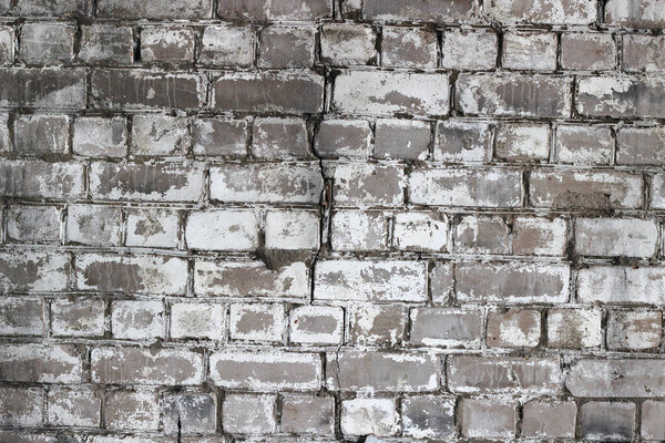 old brick wall with cracked plaster