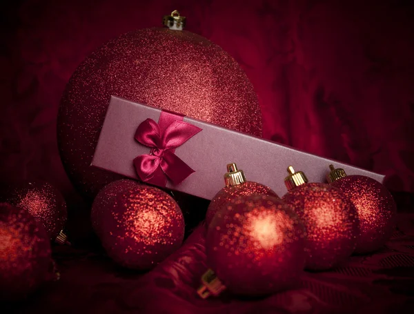 Red Christmas gift box and baubles — Stock Photo, Image