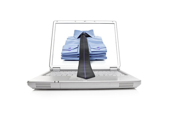 Stack of blue man's shirt and tie on laptop