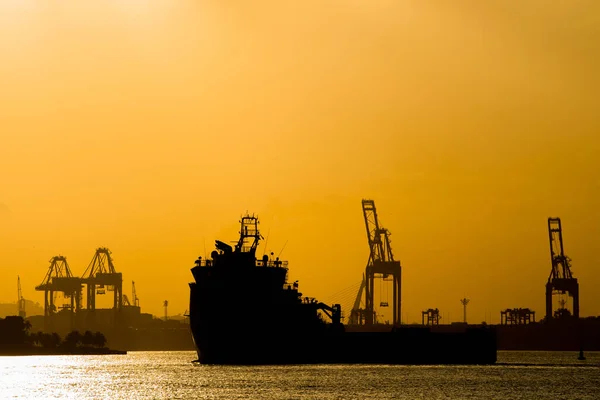 Silhouette of Industrial Ship With Cargo Cranes in the Horizon