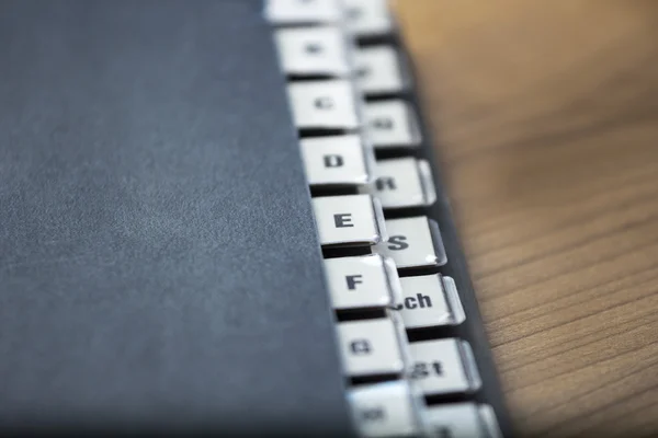 Alphabetical registry on a black folder — Stock Photo, Image